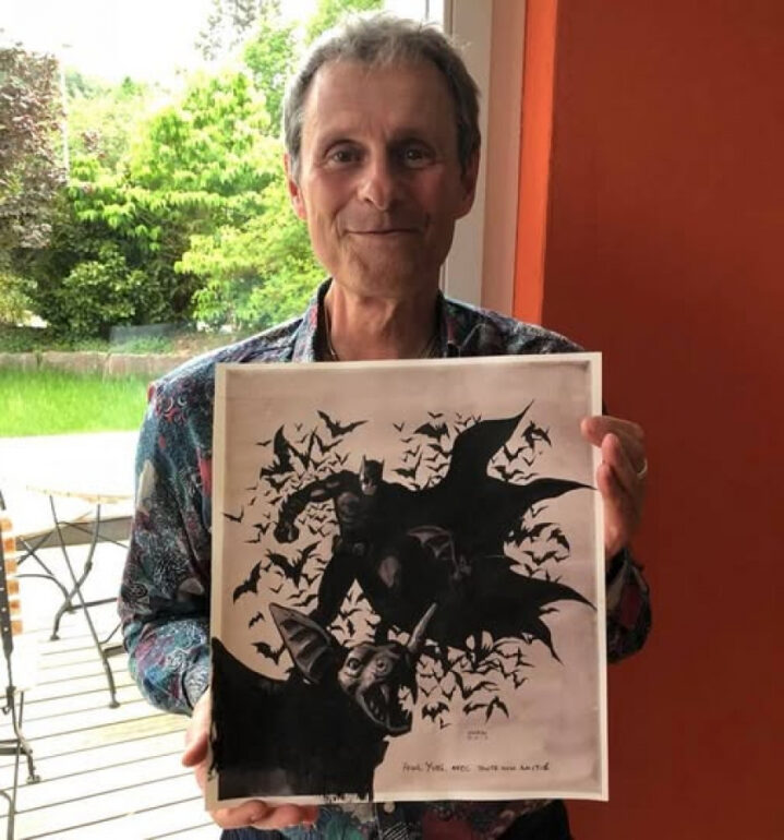 Yves Schlirf.  avec une planche originale de Batman dédicacée